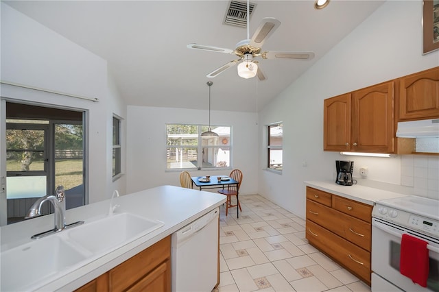 kitchen featuring pendant lighting, lofted ceiling, sink, ceiling fan, and white appliances