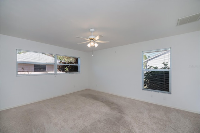 unfurnished room with ceiling fan and light colored carpet