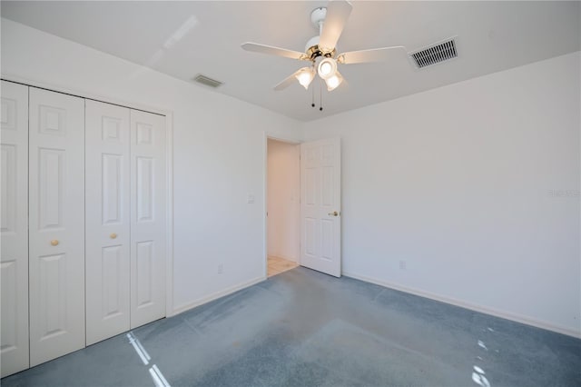 unfurnished bedroom featuring ceiling fan, dark carpet, and a closet