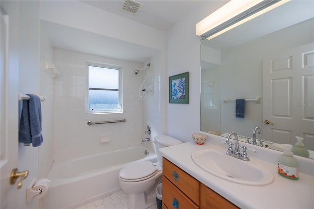 full bathroom with tiled shower / bath combo, vanity, and toilet