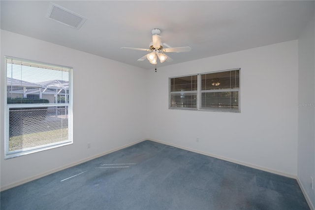 carpeted spare room with ceiling fan