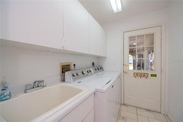 laundry room with washer and dryer, sink, light tile patterned floors, and cabinets