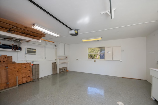 garage featuring a garage door opener and an AC wall unit