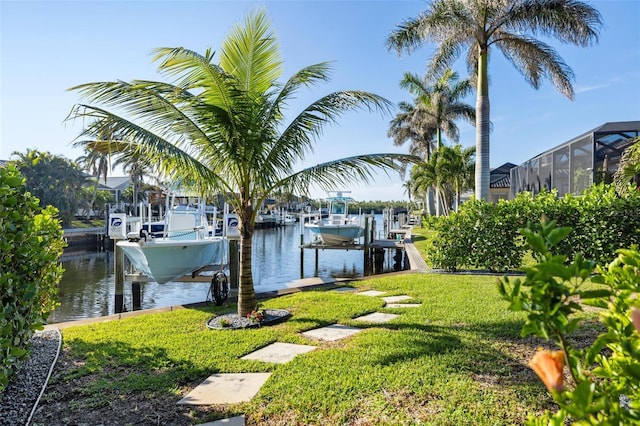 view of dock with a water view and a yard