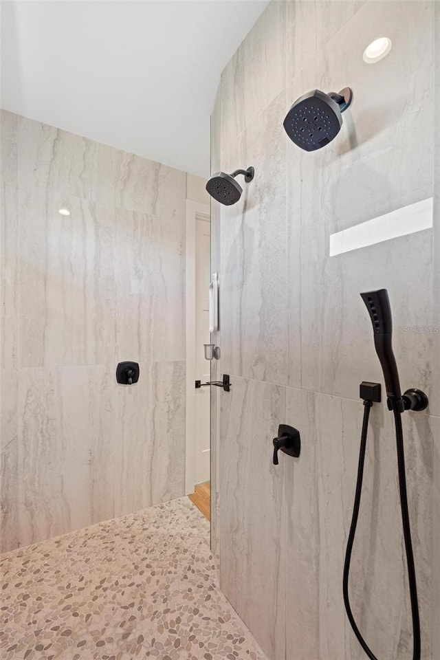 bathroom with tiled shower