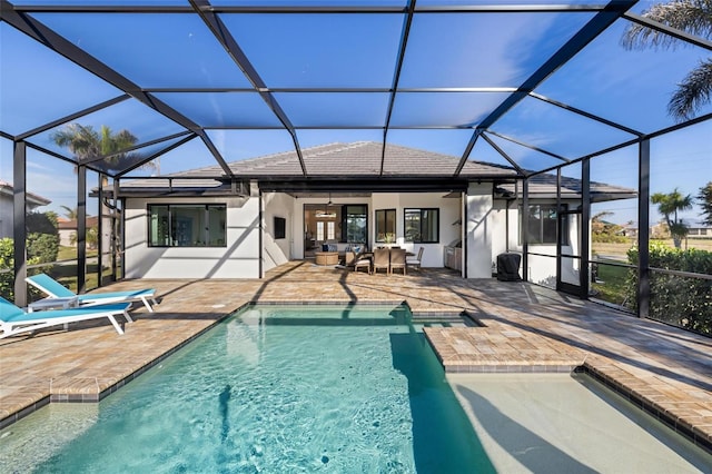 exterior space with an outdoor living space, a lanai, a patio, and ceiling fan