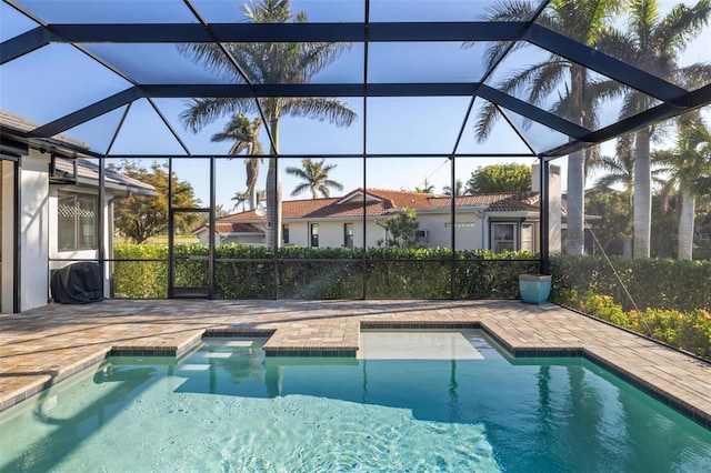 view of swimming pool with a lanai and a patio