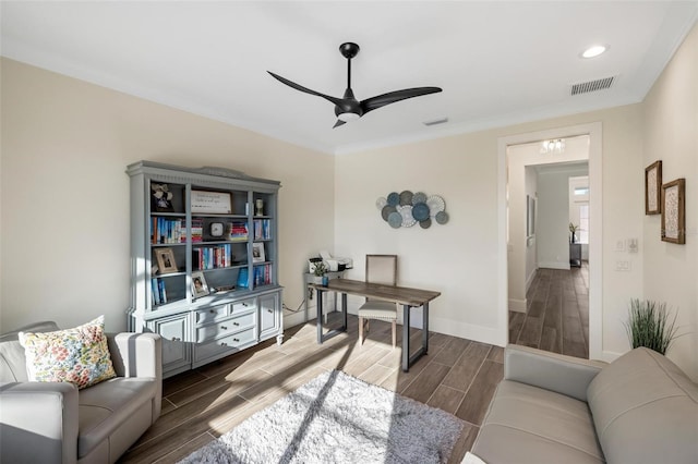 home office with ceiling fan and ornamental molding