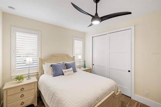 bedroom with hardwood / wood-style flooring, ceiling fan, and a closet