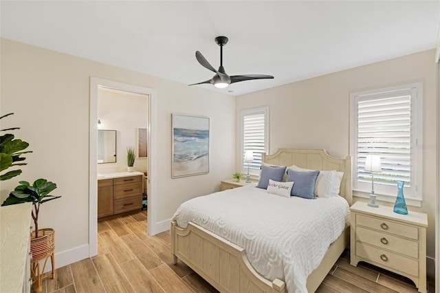 bedroom featuring multiple windows, ceiling fan, and ensuite bathroom