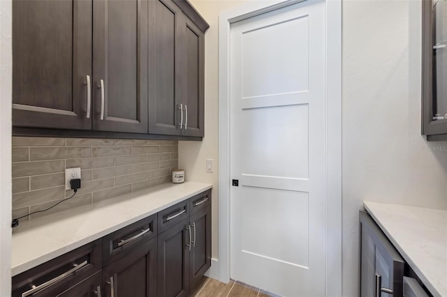 kitchen with dark brown cabinets and backsplash