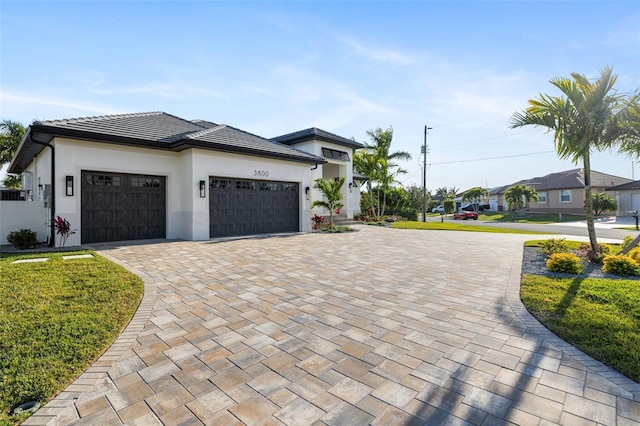 view of front of home with a garage and a front yard