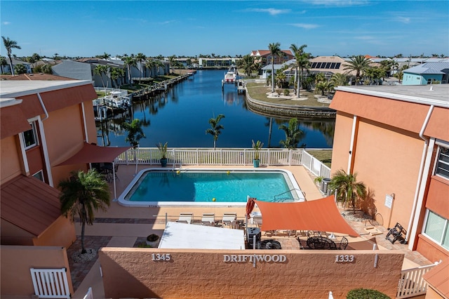 view of pool with a water view and a patio area