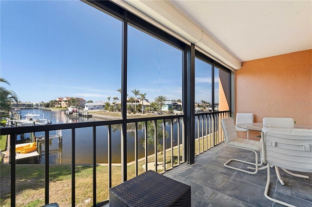 sunroom / solarium with a water view