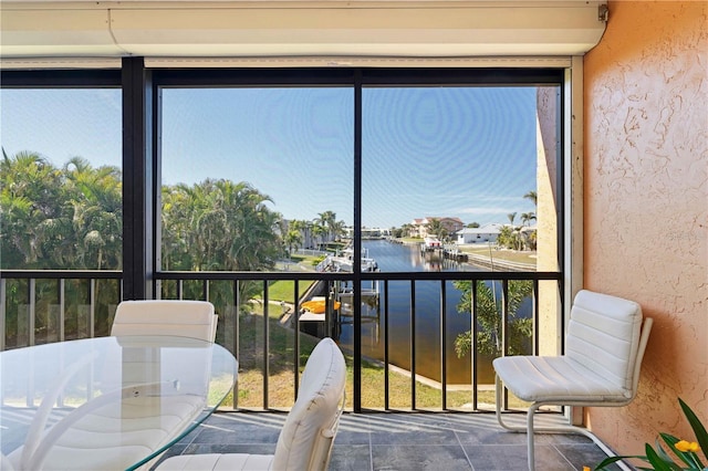 sunroom / solarium with a water view