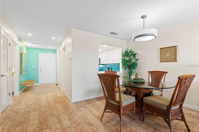 dining space featuring light wood-type flooring