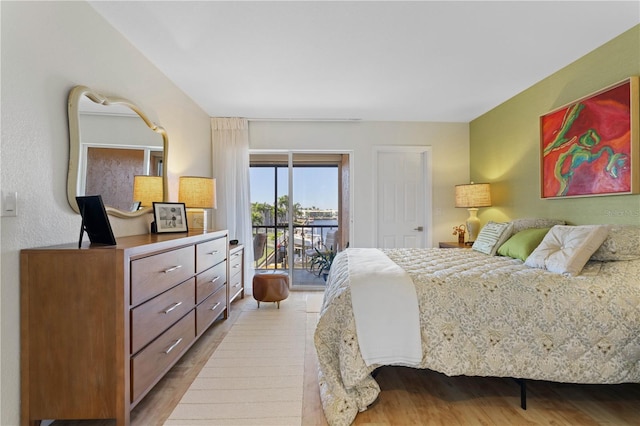 bedroom with access to exterior and light wood-type flooring