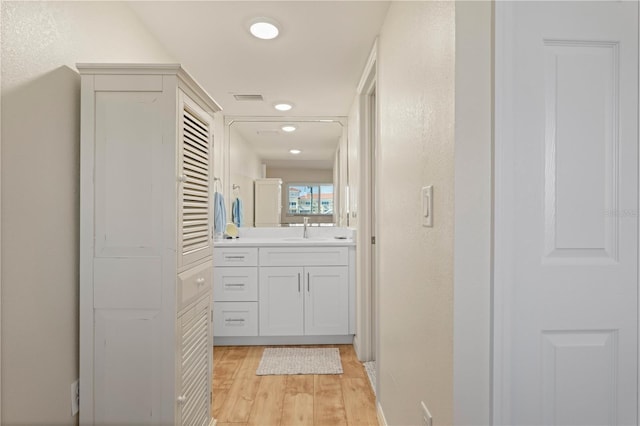 bathroom featuring wood-type flooring and vanity