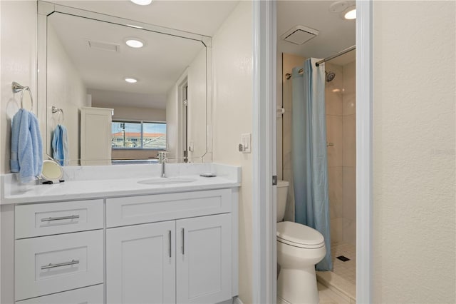 bathroom featuring walk in shower, vanity, and toilet