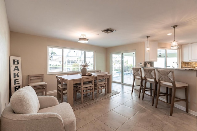 dining area with sink and light tile patterned floors