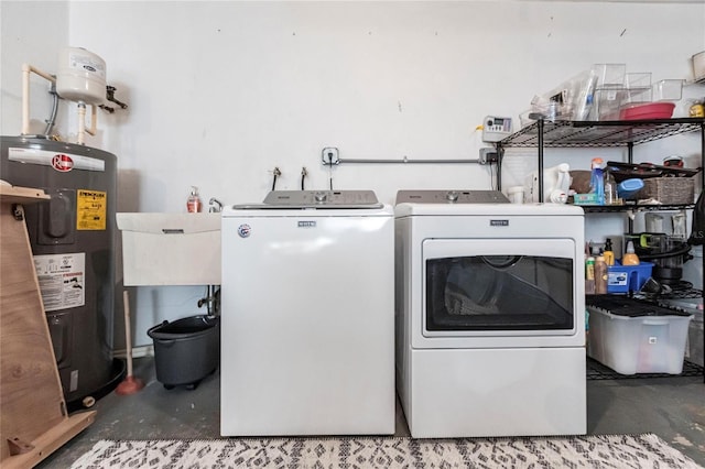 washroom featuring washing machine and dryer, electric water heater, and sink