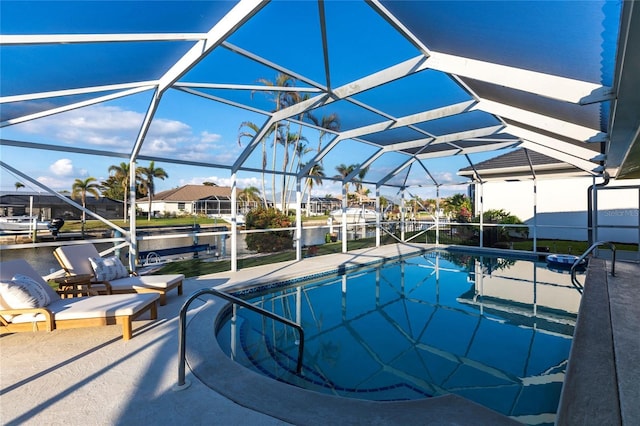 view of pool with a water view, a lanai, and a patio