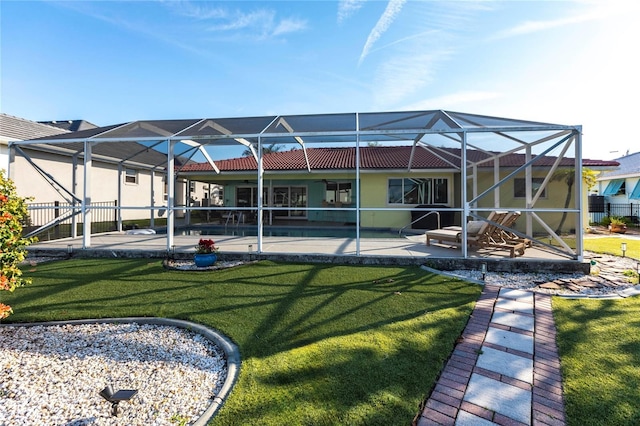 back of property featuring a lanai, a patio, and a lawn