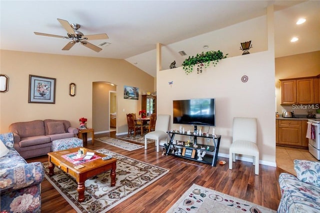 living room featuring ceiling fan, lofted ceiling, and hardwood / wood-style floors