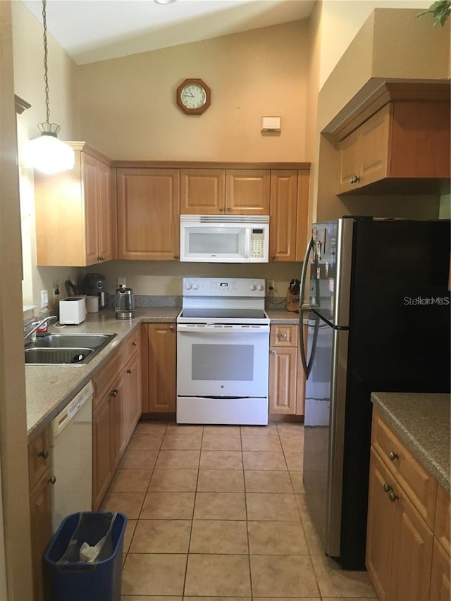 kitchen featuring light tile patterned flooring, sink, hanging light fixtures, a towering ceiling, and white appliances