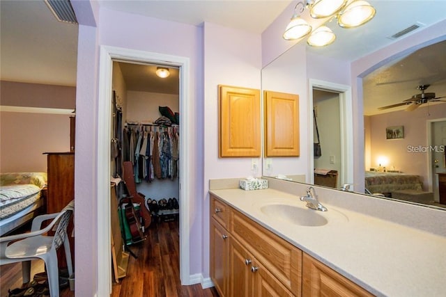 bathroom featuring ceiling fan, vanity, and hardwood / wood-style floors