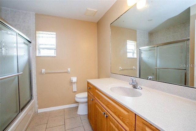 full bathroom with shower / bath combination with glass door, vanity, toilet, and tile patterned flooring