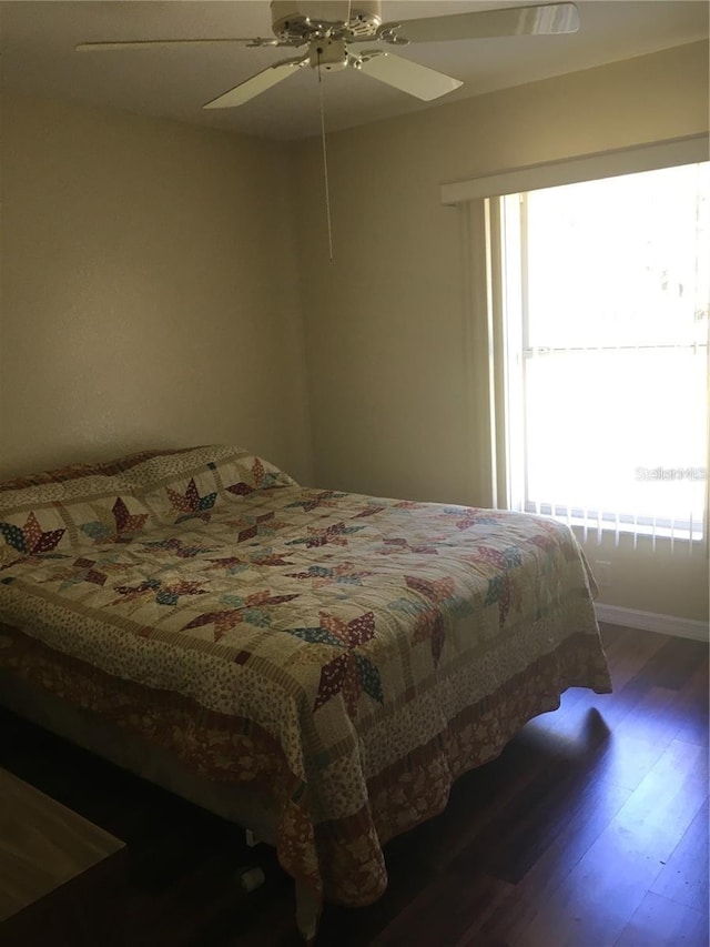 bedroom featuring dark wood-type flooring and ceiling fan