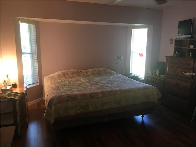 bedroom with dark wood-type flooring