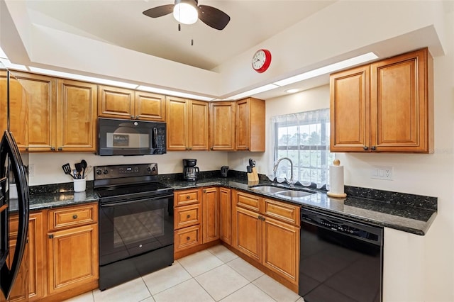 kitchen with sink, light tile patterned floors, ceiling fan, dark stone countertops, and black appliances