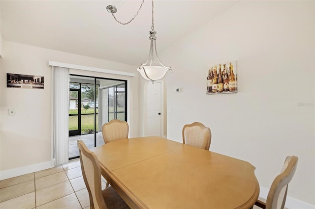 tiled dining space with vaulted ceiling