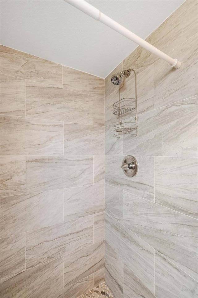 bathroom with tiled shower