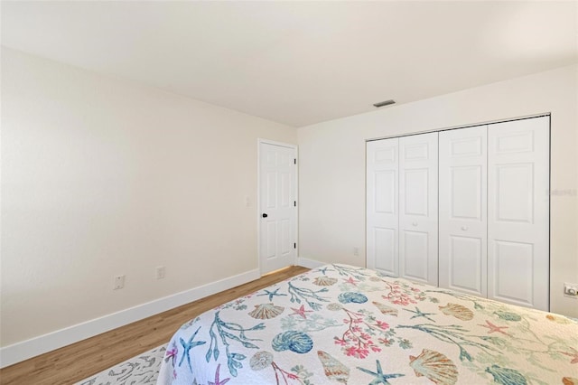 bedroom featuring wood-type flooring and a closet