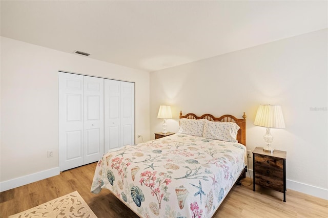 bedroom featuring hardwood / wood-style floors and a closet