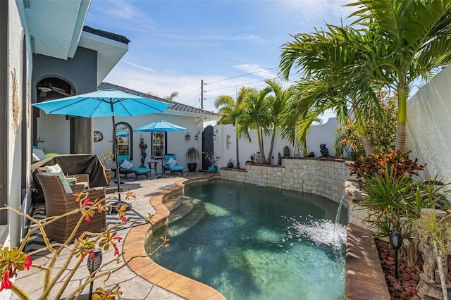 view of swimming pool featuring pool water feature and a patio area