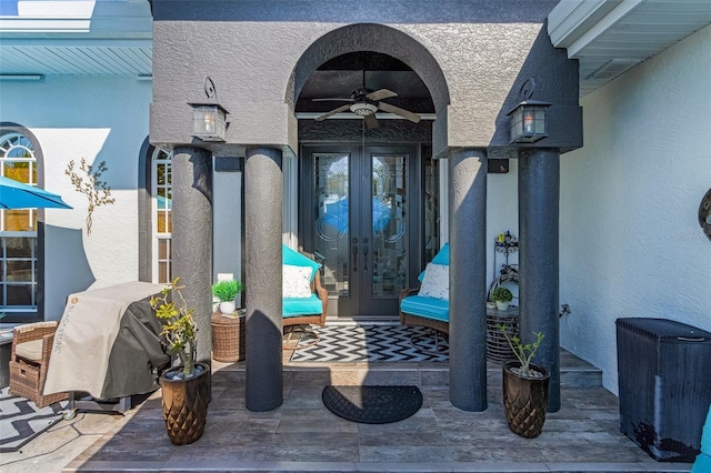 property entrance featuring french doors and ceiling fan