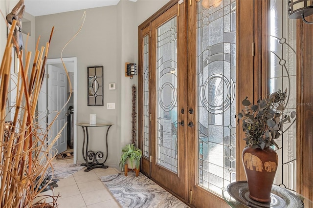 foyer entrance featuring light tile patterned floors and french doors