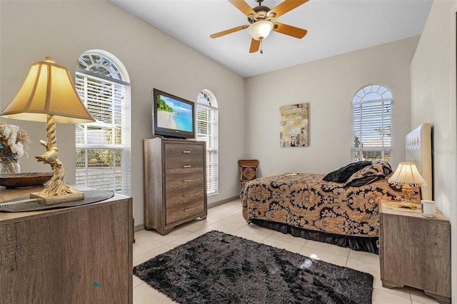 tiled bedroom featuring ceiling fan