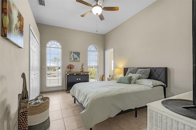 tiled bedroom featuring a closet and ceiling fan