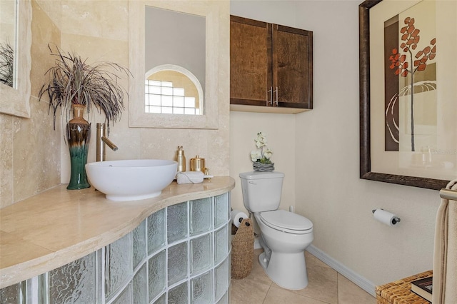 bathroom featuring tile patterned flooring, sink, and toilet