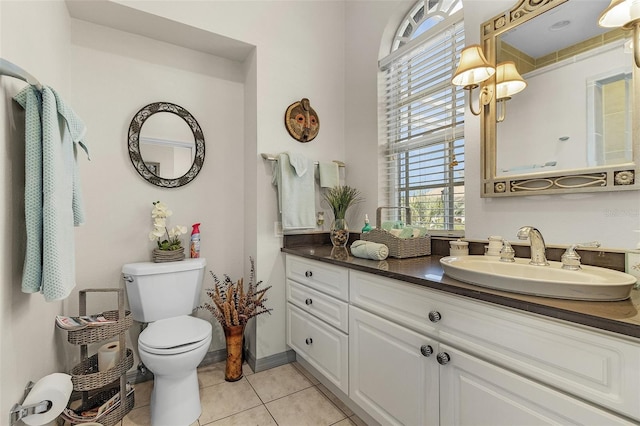 bathroom featuring vanity, tile patterned floors, and toilet