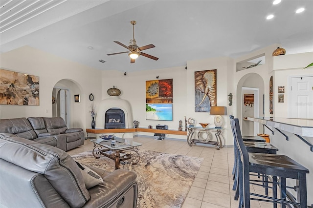 living room with ceiling fan and light tile patterned floors