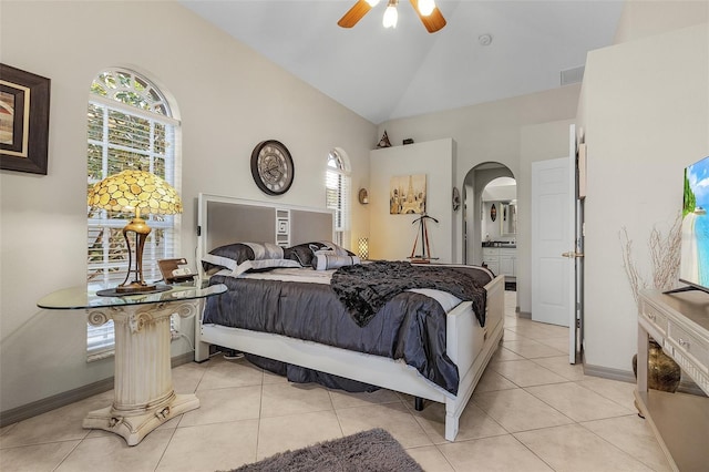 tiled bedroom featuring ceiling fan, connected bathroom, and high vaulted ceiling