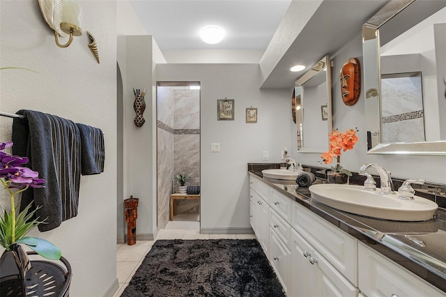 bathroom featuring vanity, tile patterned floors, and tiled shower