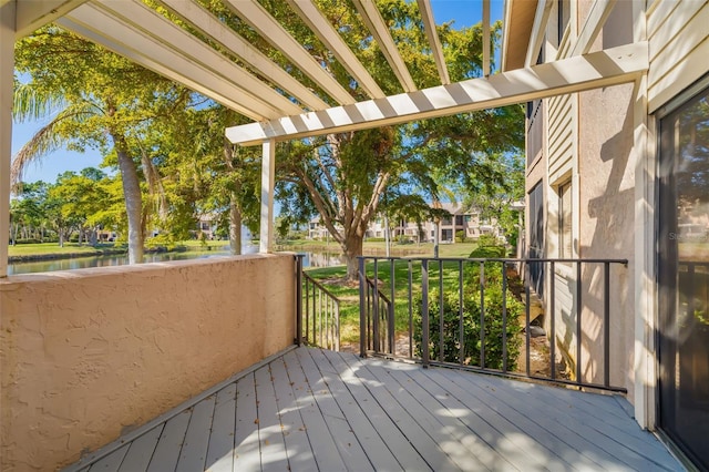 deck featuring a pergola and a water view