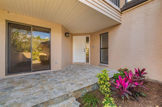 entrance to property featuring a patio